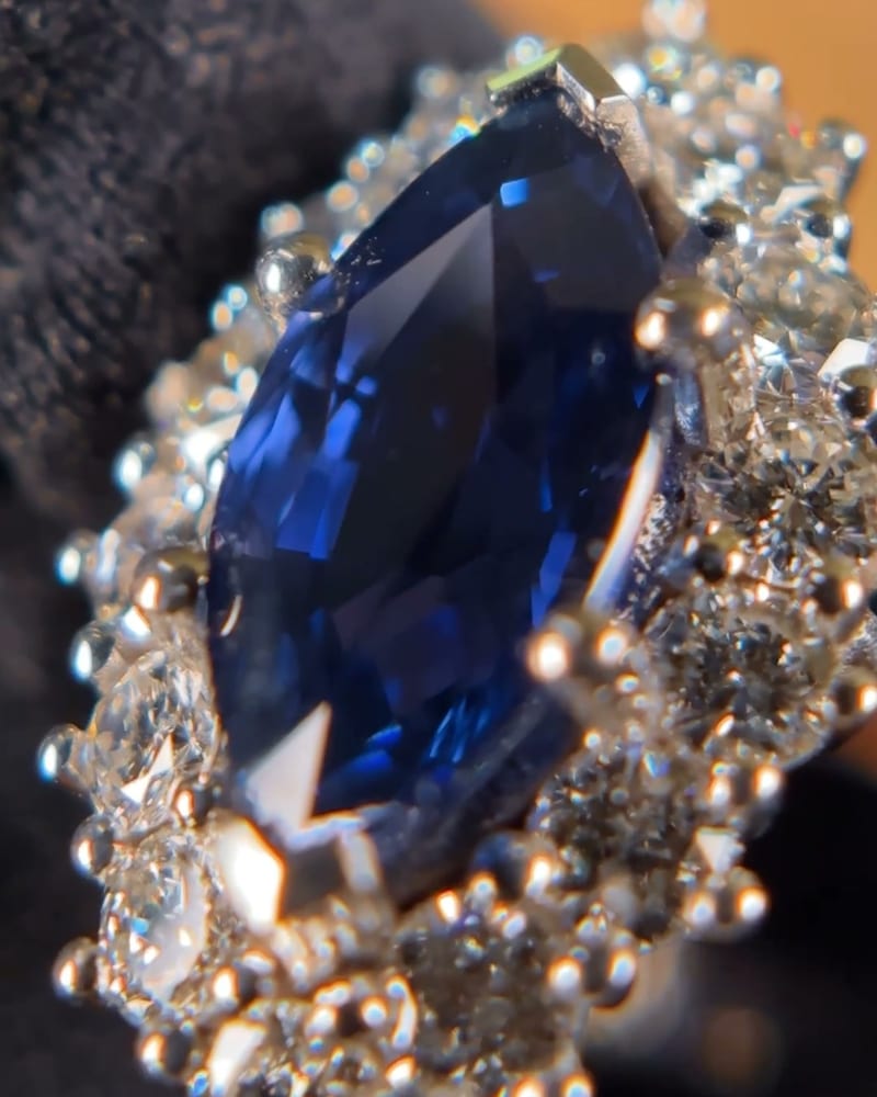 Close-up of the marquise sapphire and the claw-set diamonds